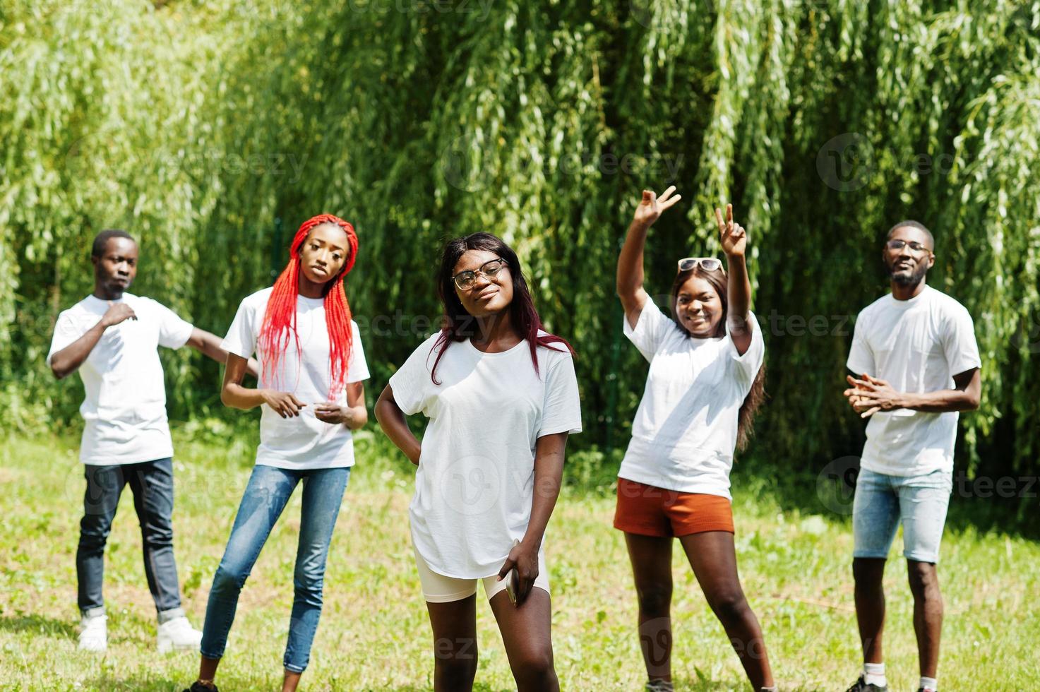 Group of african american peoples in park at white t-shirts. photo