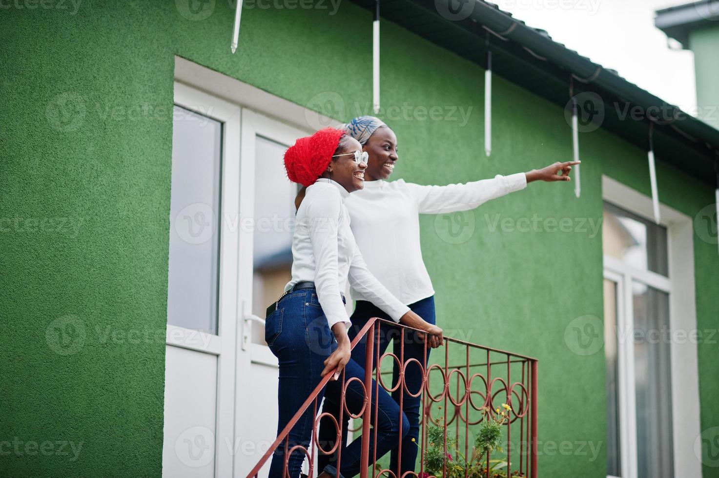Two young modern fashionable, attractive, tall and slim african muslim womans in hijab or turban head scarf posed together. photo