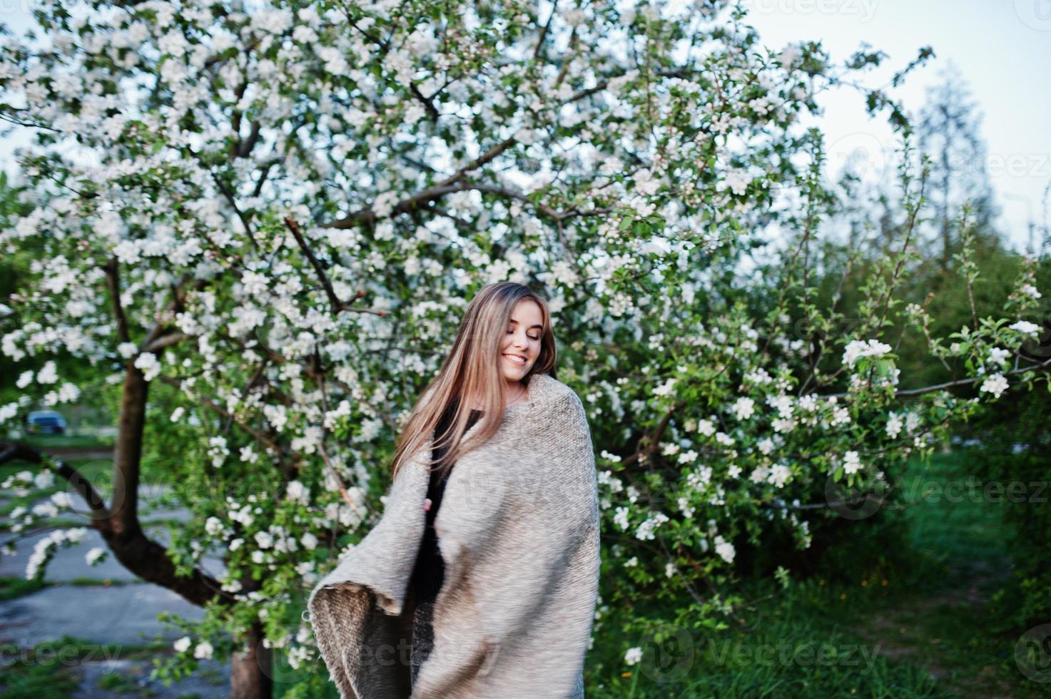 Young brunette girl on plaid having fun at evening spring day. photo