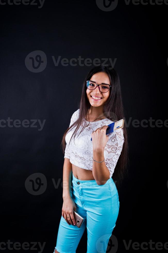 Portrait of a happy woman posing with passport and glasses. photo