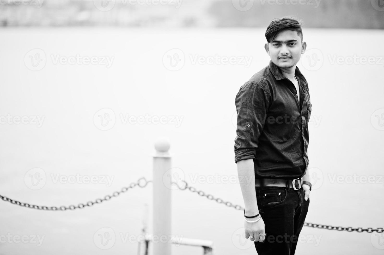 Indian man in brown shirt posed outdoor. photo