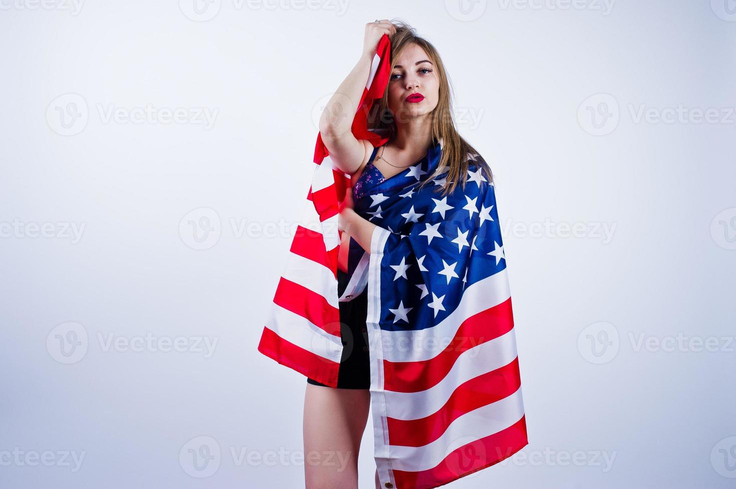 Cute girl in bra and shorts with american usa flag isolated on white background. photo