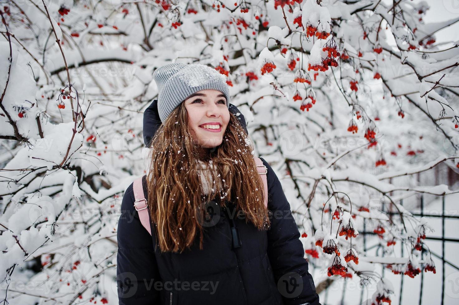 Portrait of girl at winter snowy day near snow covered trees. photo