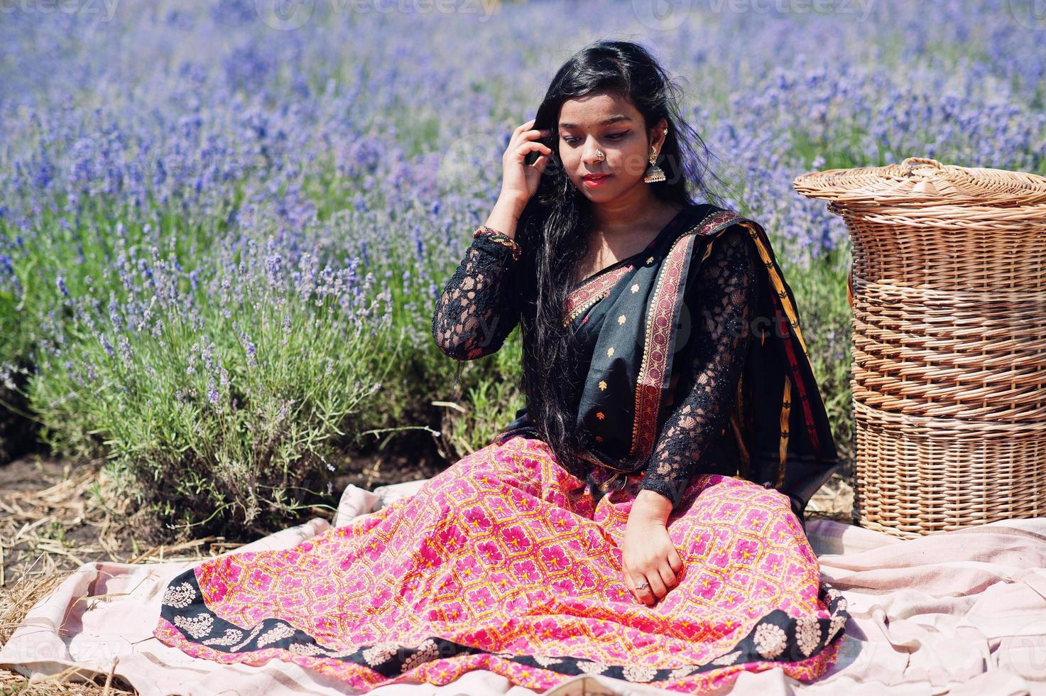 Beautiful indian girl wear saree india traditional dress in purple lavender field. photo