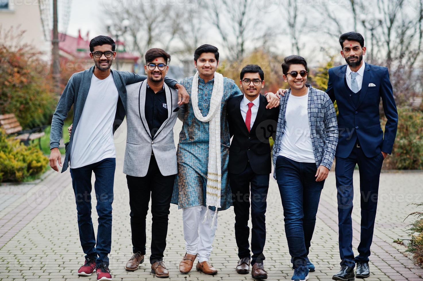 Group of six south asian indian mans in traditional, casual and business wear walking. photo