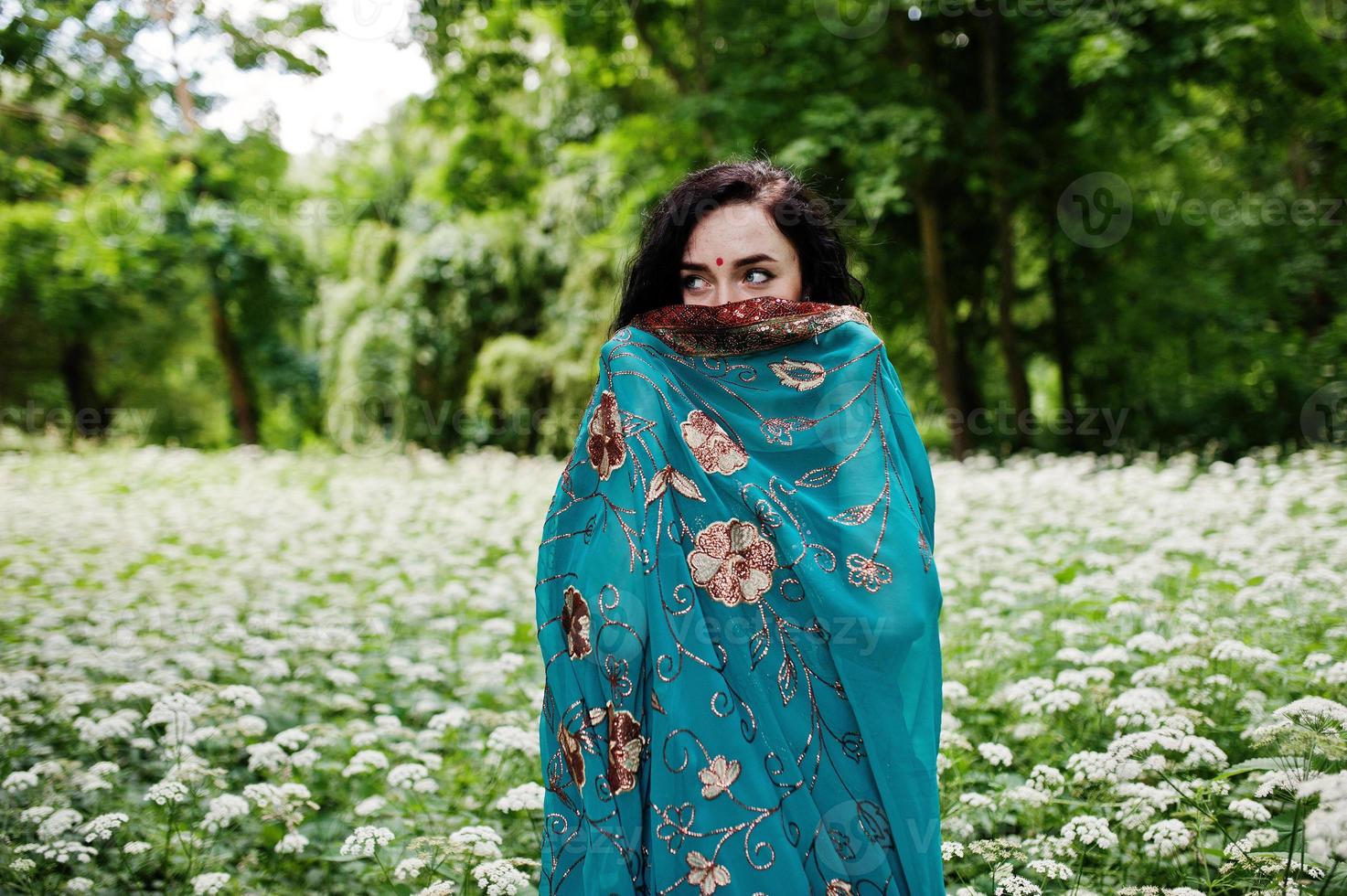 Portrait of beautiful indian brumette girl or hindu woman model. Traditional Indian costume lehenga choli. photo