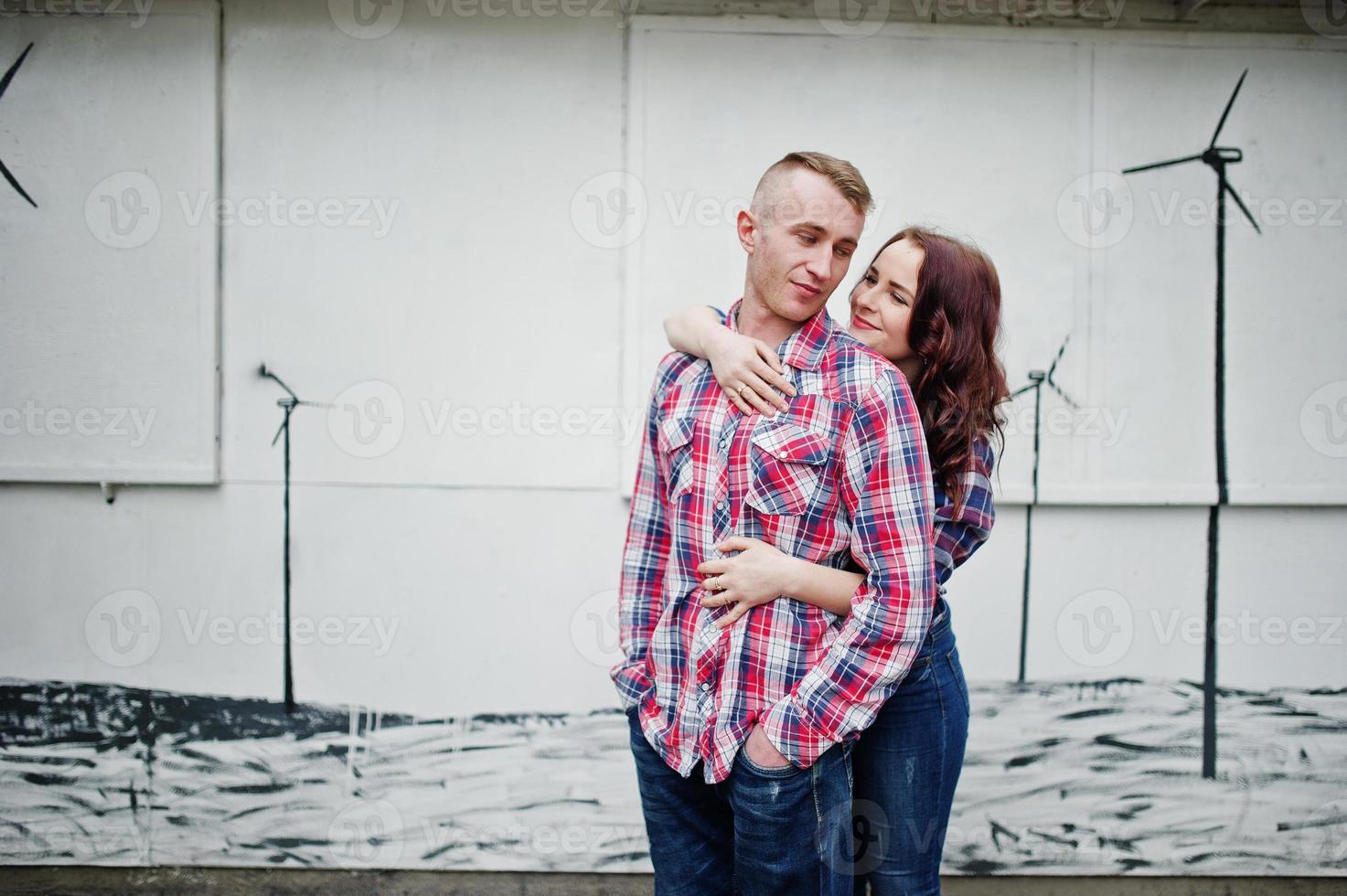 Stylish couple wear on checkered shirt in love together. photo