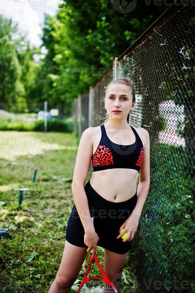 Beautiful sport woman tennis player with racket in sportswear costume. photo