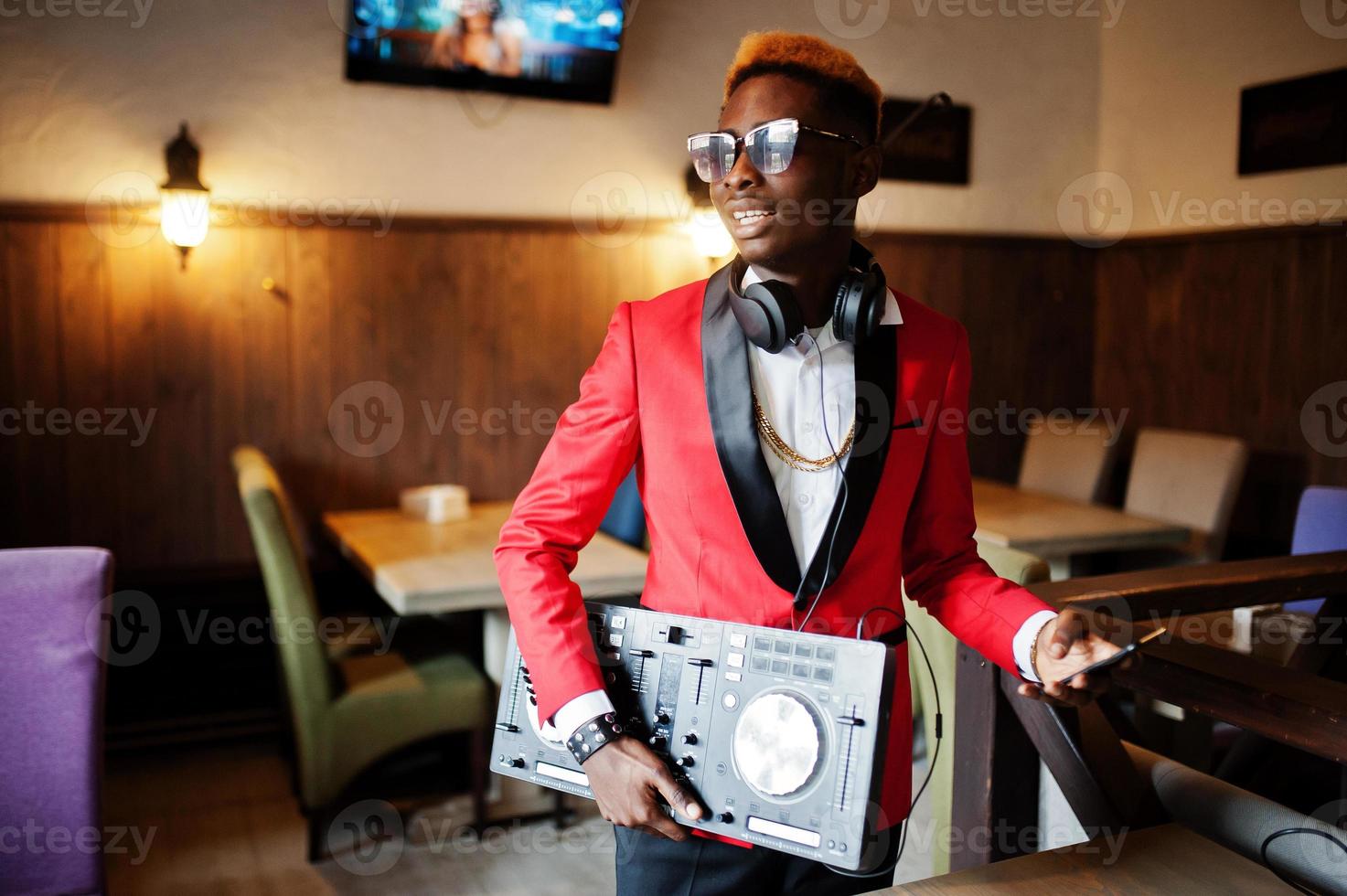 Fashion african american man model DJ at red suit with dj controller. photo