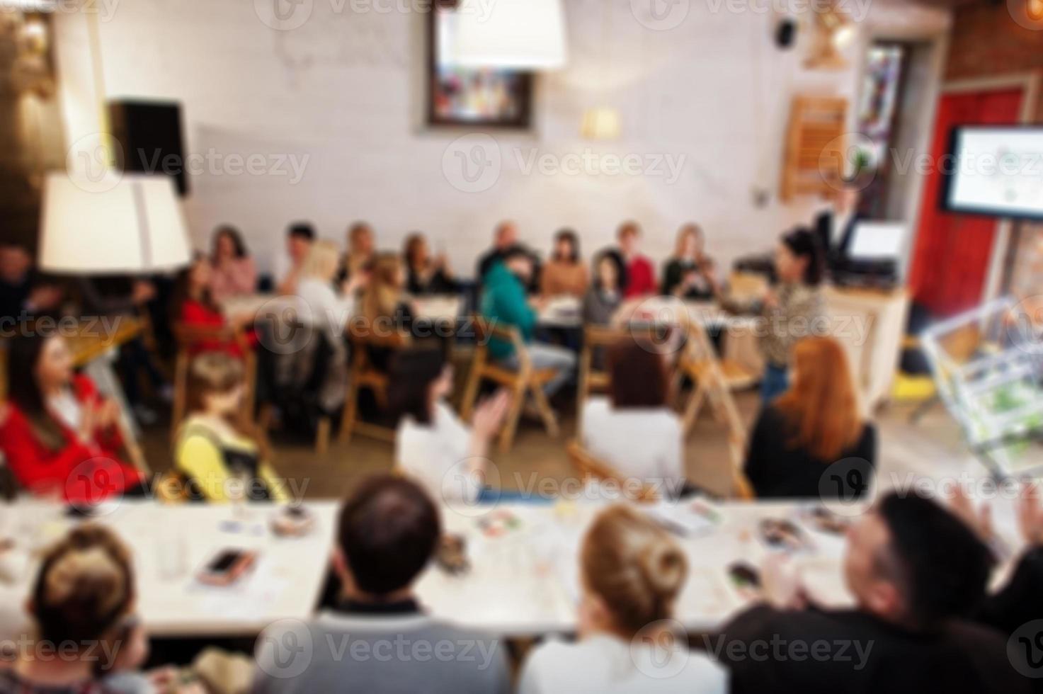 Master class and study concept. Abstract blurred photo of conference or seminar room with speaker on the stage.