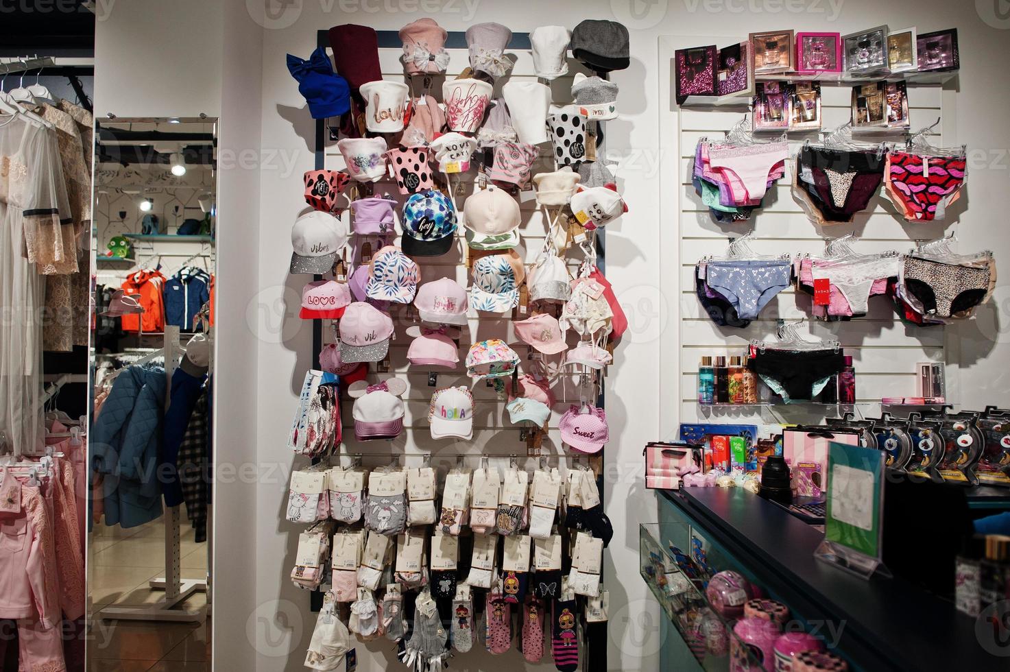 Luxury and fashionable brand new interior of kids  hats and caps cloth store. photo