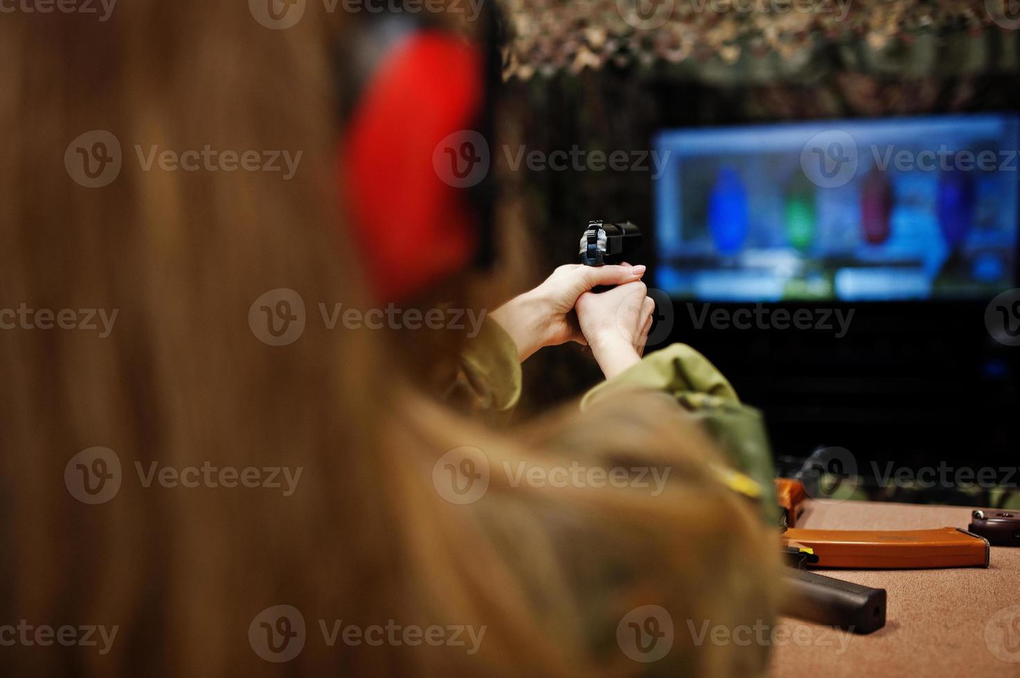 Shooting at the shooting range.The woman at the shooting range shot from gun. photo