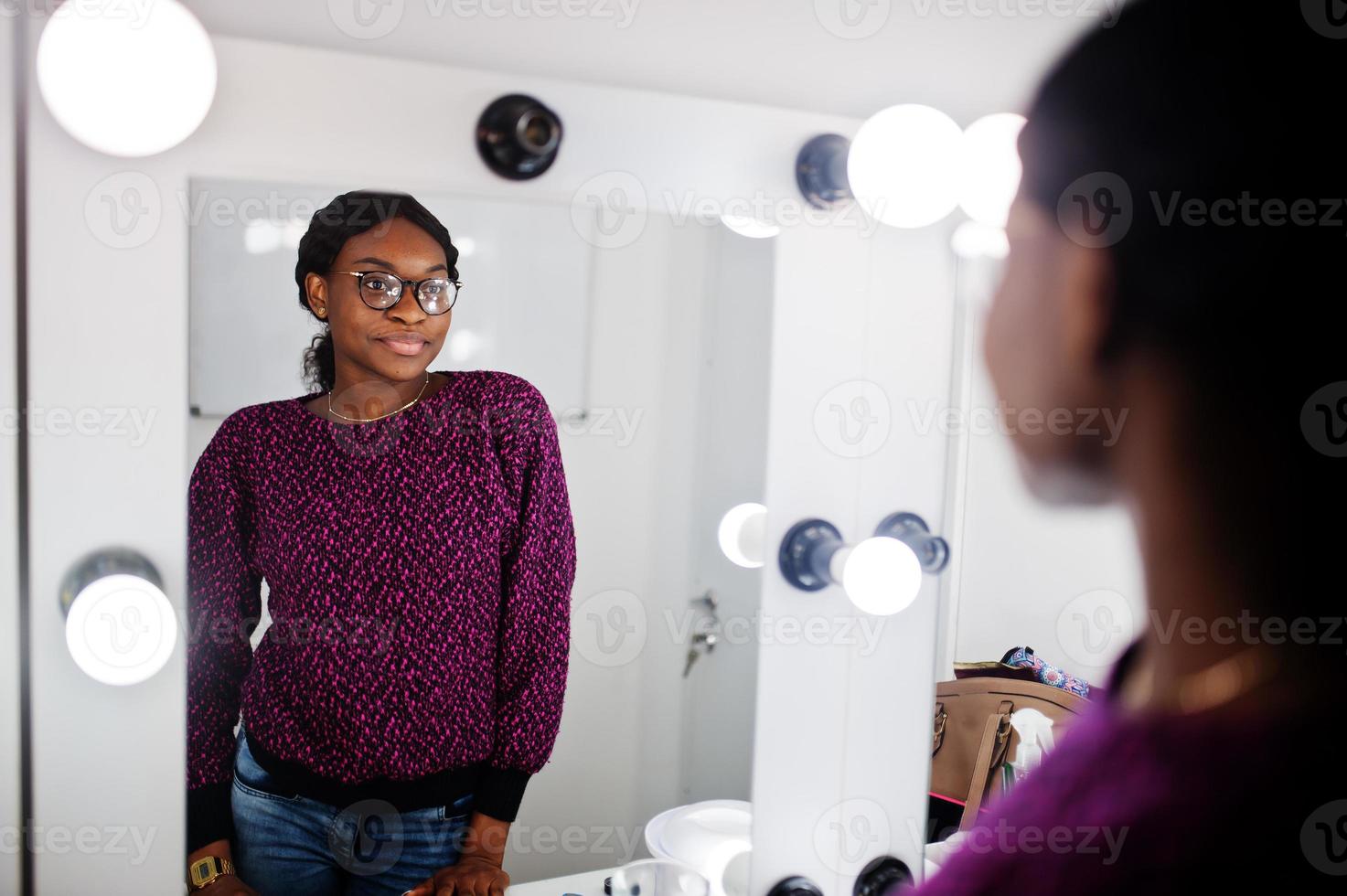 African American woman make-up artist at beauty saloon. photo