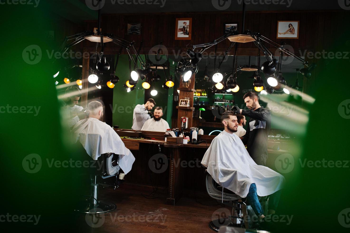 Handsome bearded man at the barbershop, barber at work. photo