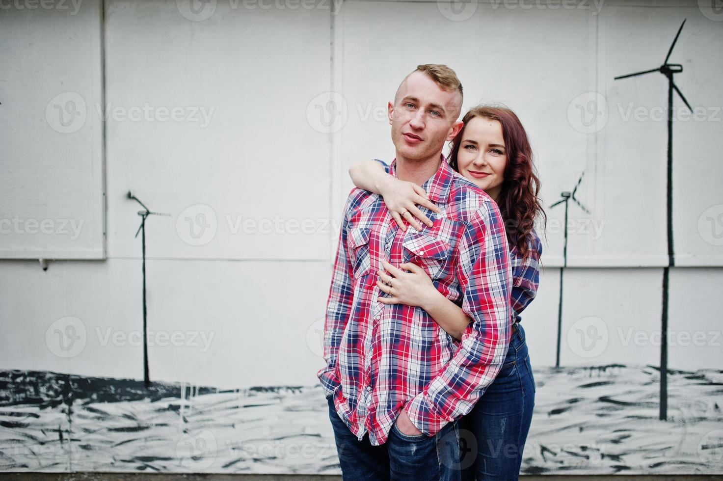 Stylish couple wear on checkered shirt in love together. photo