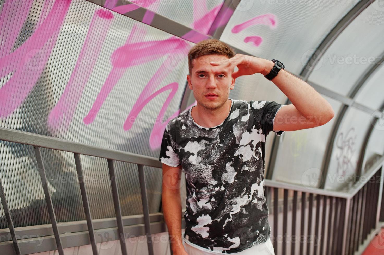 Lifestyle portrait of handsome man posing on the city tonnel. photo