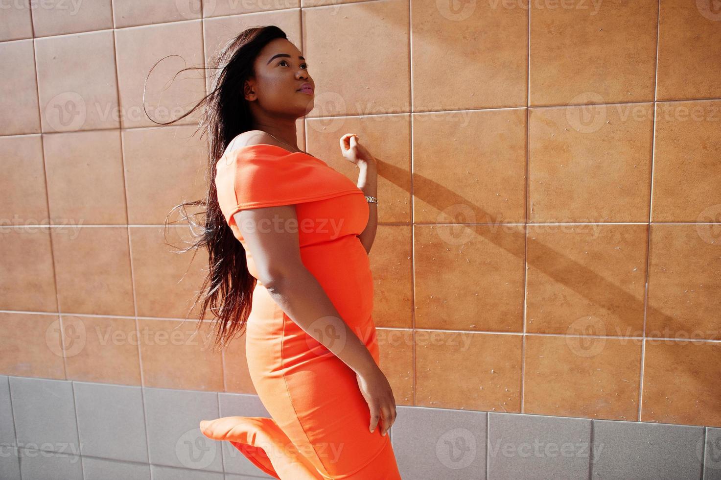 African american woman model xxl in orange dress. photo