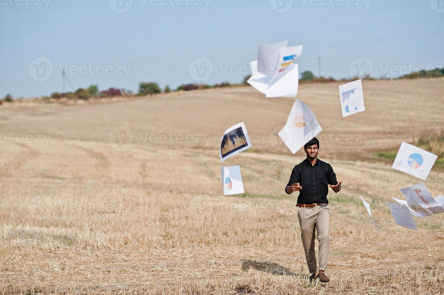 South asian agronomist farmer threw the papers into the sky at wheat field. Agriculture production concept. photo