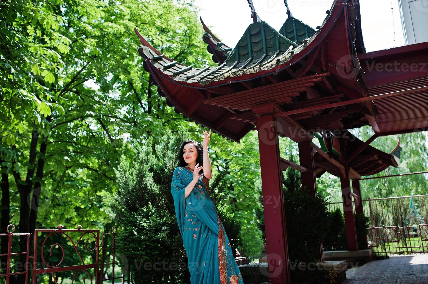 Portrait of beautiful indian brumette girl or hindu woman model against japanese traditional house. photo