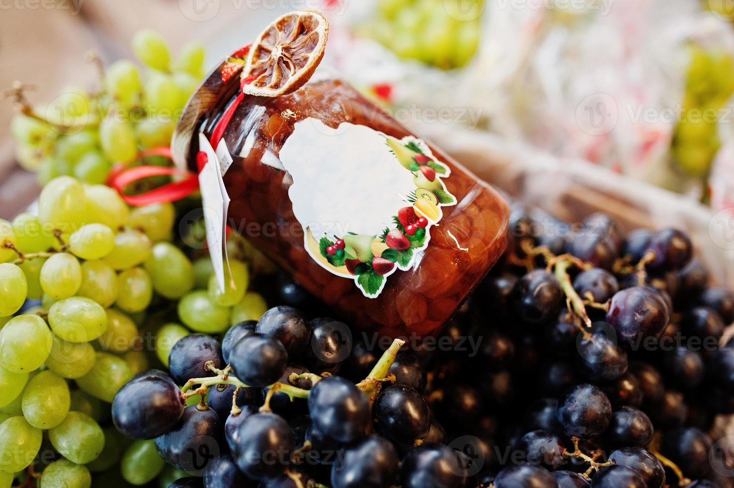 Hommemade jar with grapes on the shelf of a supermarket or grocery store. photo