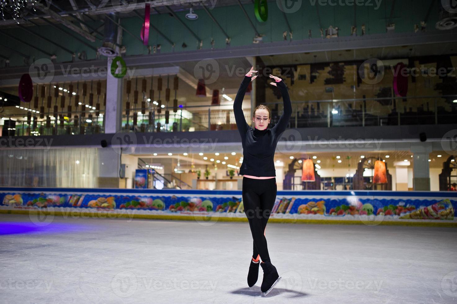 Figure skater woman at ice skating rink. photo