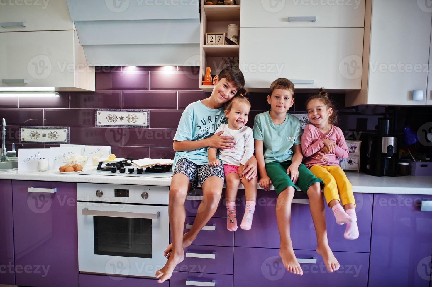 Kids cooking at kitchen, happy children's moments. Four kid, large family. photo