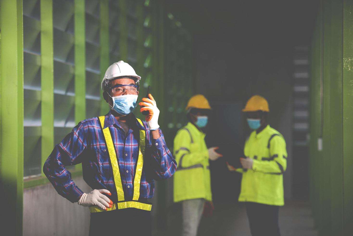 The construction supervisor inspects the warehouse at the workplace with the team photo