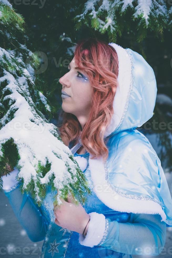 Attractive red haired woman in winter cape photo