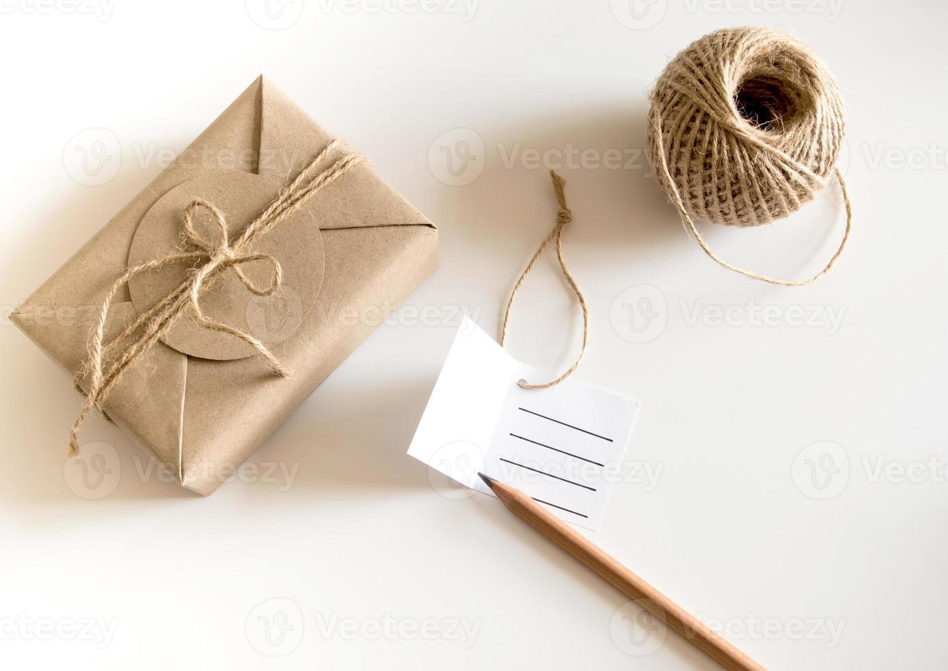 Gift box wrapped in kraft paper and rustic hemp as natural rustic style photo