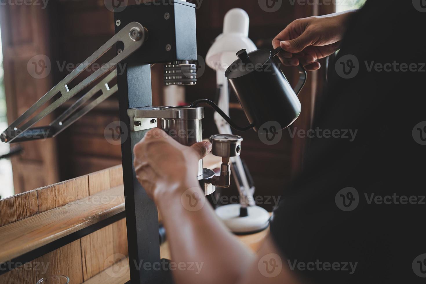 Barista cafe making coffee with manual lever espresso machine preparation service concept in restaurant. Close up hand barista making fresh coffee with coffee machine in the cafe. Making fresh coffee. photo