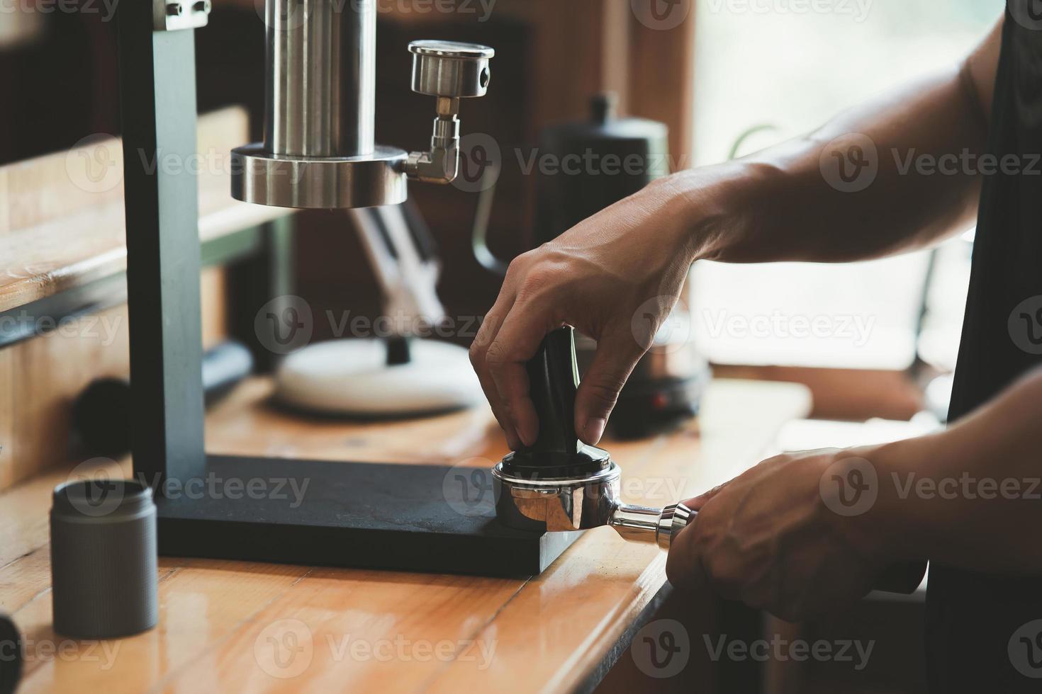 Barista cafe making coffee with manual lever espresso machine preparation service concept in restaurant. Close up hand barista making fresh coffee with coffee machine in the cafe. Making fresh coffee. photo