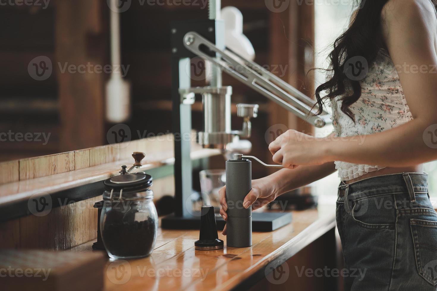 Barista cafe making coffee with manual lever espresso machine preparation service concept in restaurant. Close up hand barista making fresh coffee with coffee machine in the cafe. Making fresh coffee. photo