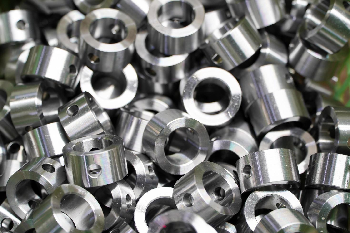 Shiny steel parts background. Regular industrial metal production pattern with selective focus.High precision steel automotive parts manufacturing by innovative CNC machining photo