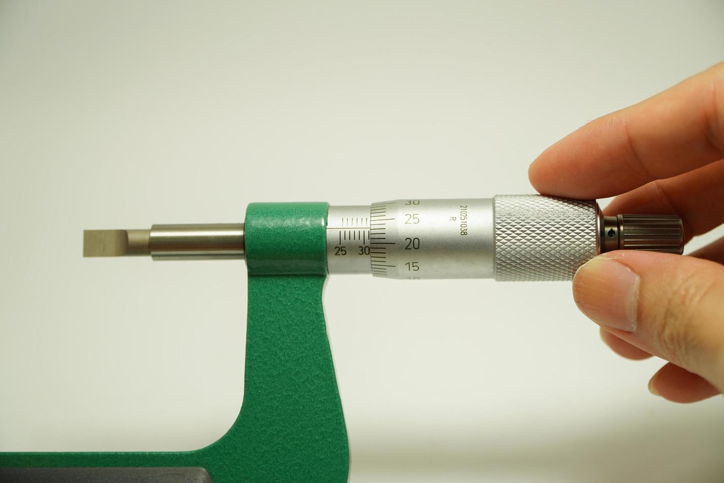 blade micrometer engineer's hand has a non-rotating spindle with a flat blade for the contact point,Measuring instrument industry concept photo