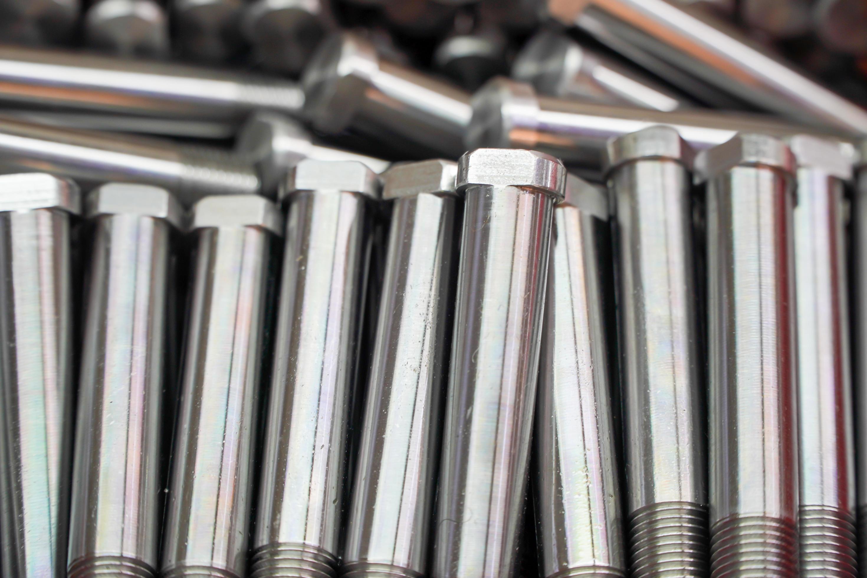 Shiny steel parts background. Regular industrial metal production