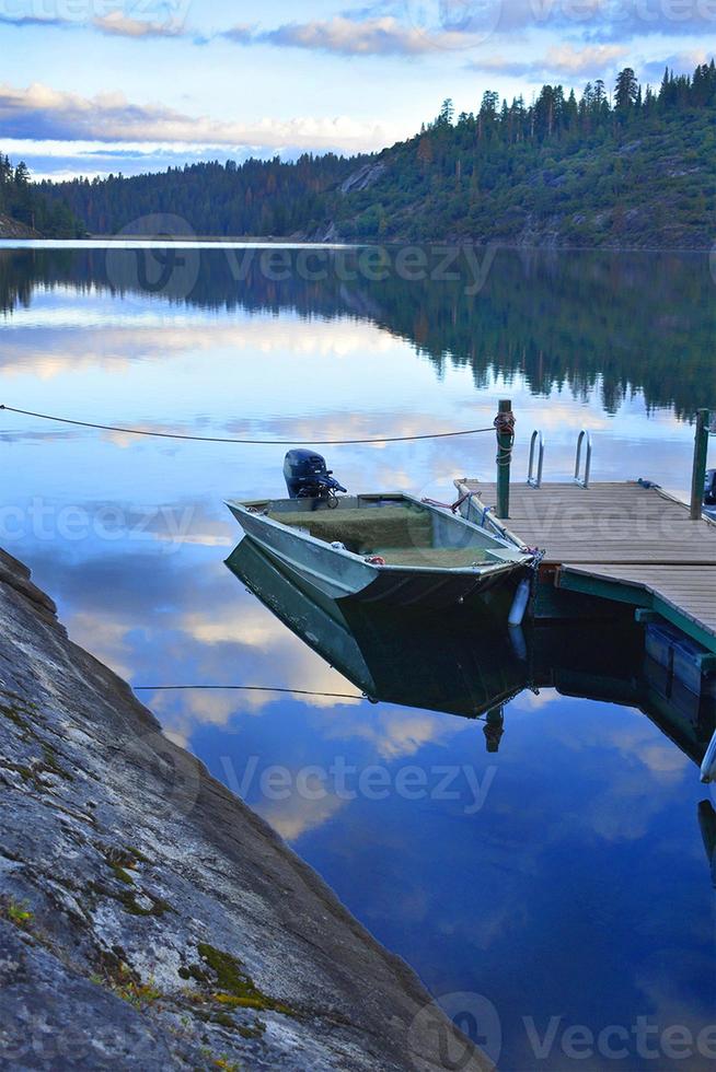 Cloud Reflection on Calm Lake with Boat Dock photo