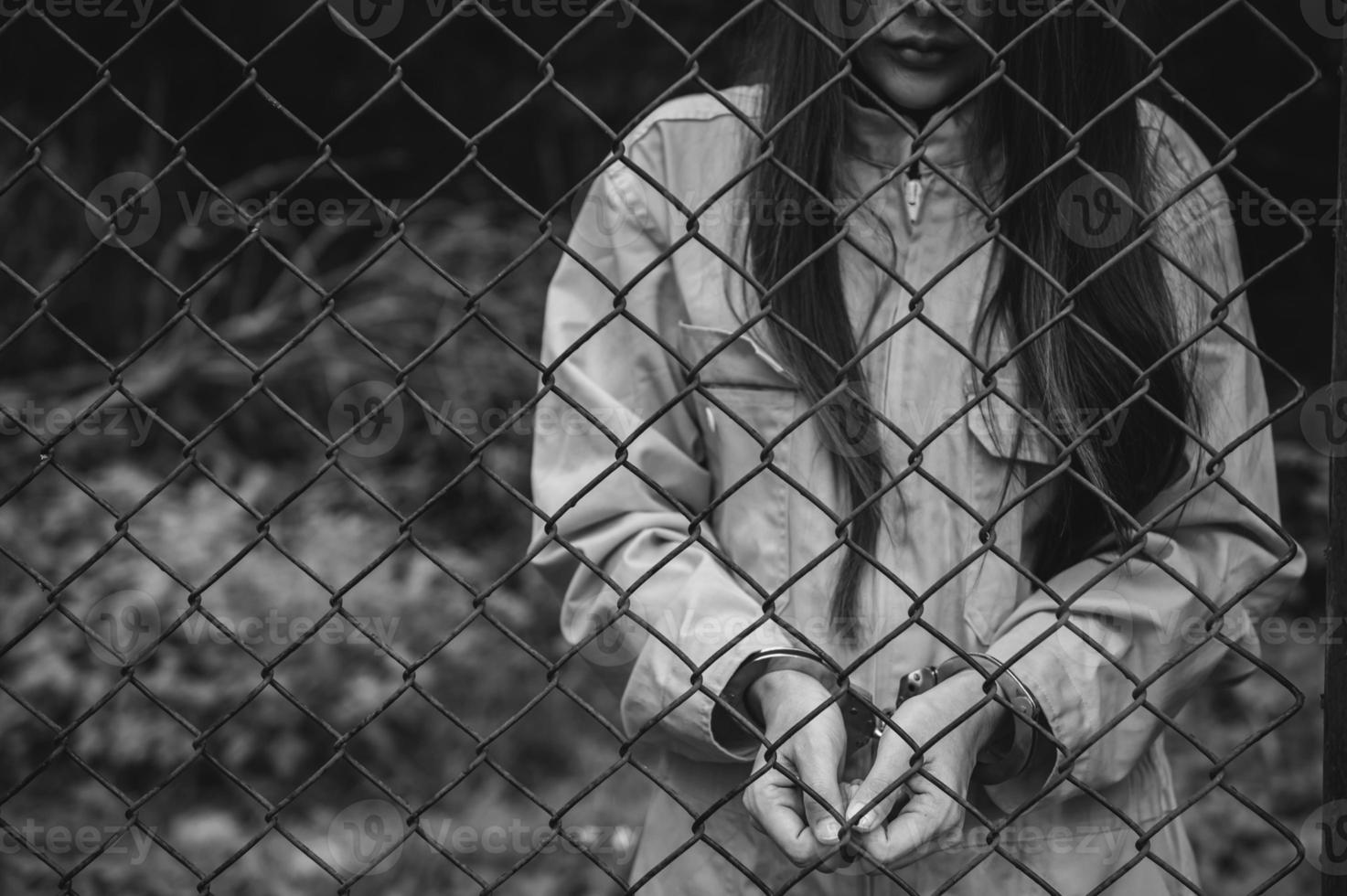 Portrait of women desperate to catch the iron prison,prisoner concept,thailand people,Hope to be free,If the violate the law would be arrested and jailed. photo