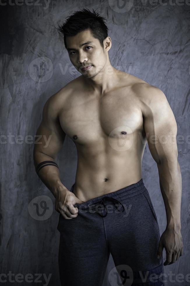 Portrait of asian man big muscle at the gym,Thailand people,Workout for good healthy,Body weight training,Fitness at the gym concept photo