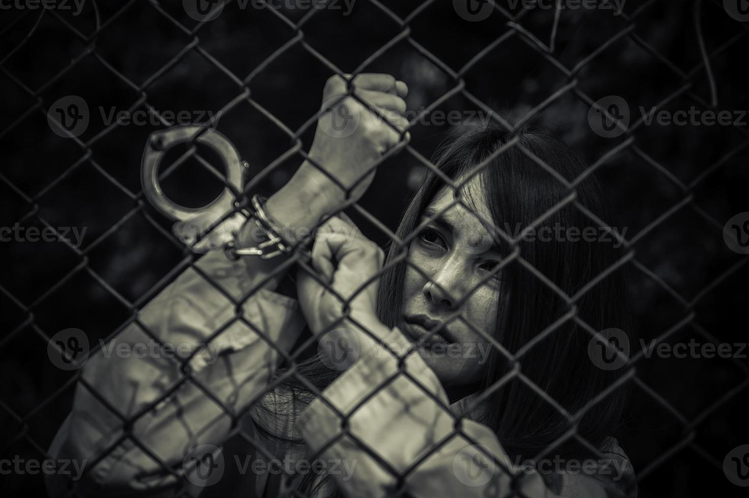 Portrait of women desperate to catch the iron prison,prisoner concept,thailand people,Hope to be free,If the violate the law would be arrested and jailed. photo