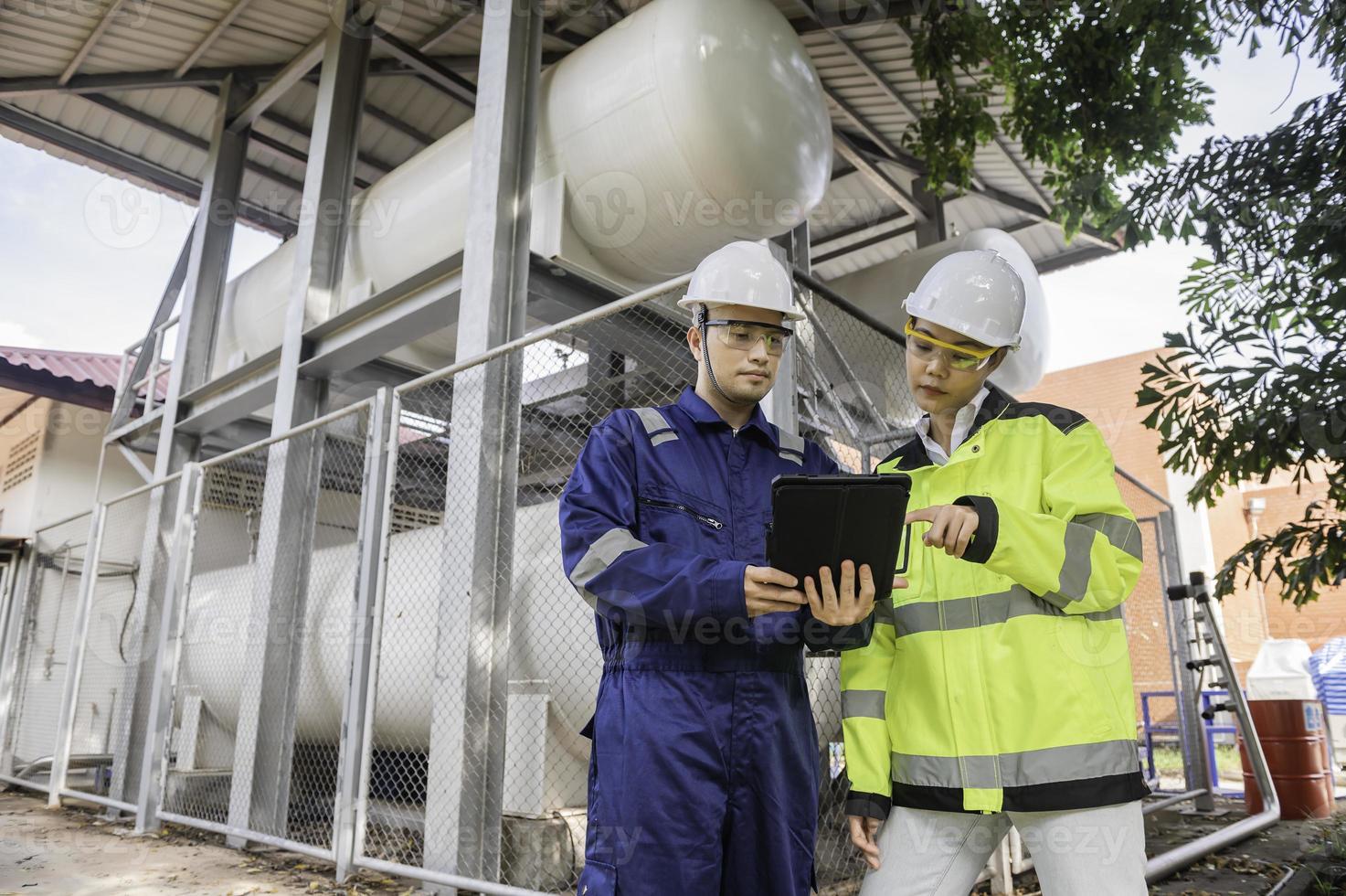 Engineers work place to keep liquid helium,preventive maintenance schedule checking,Thailand people,Technicians and engineers discuss work together. photo