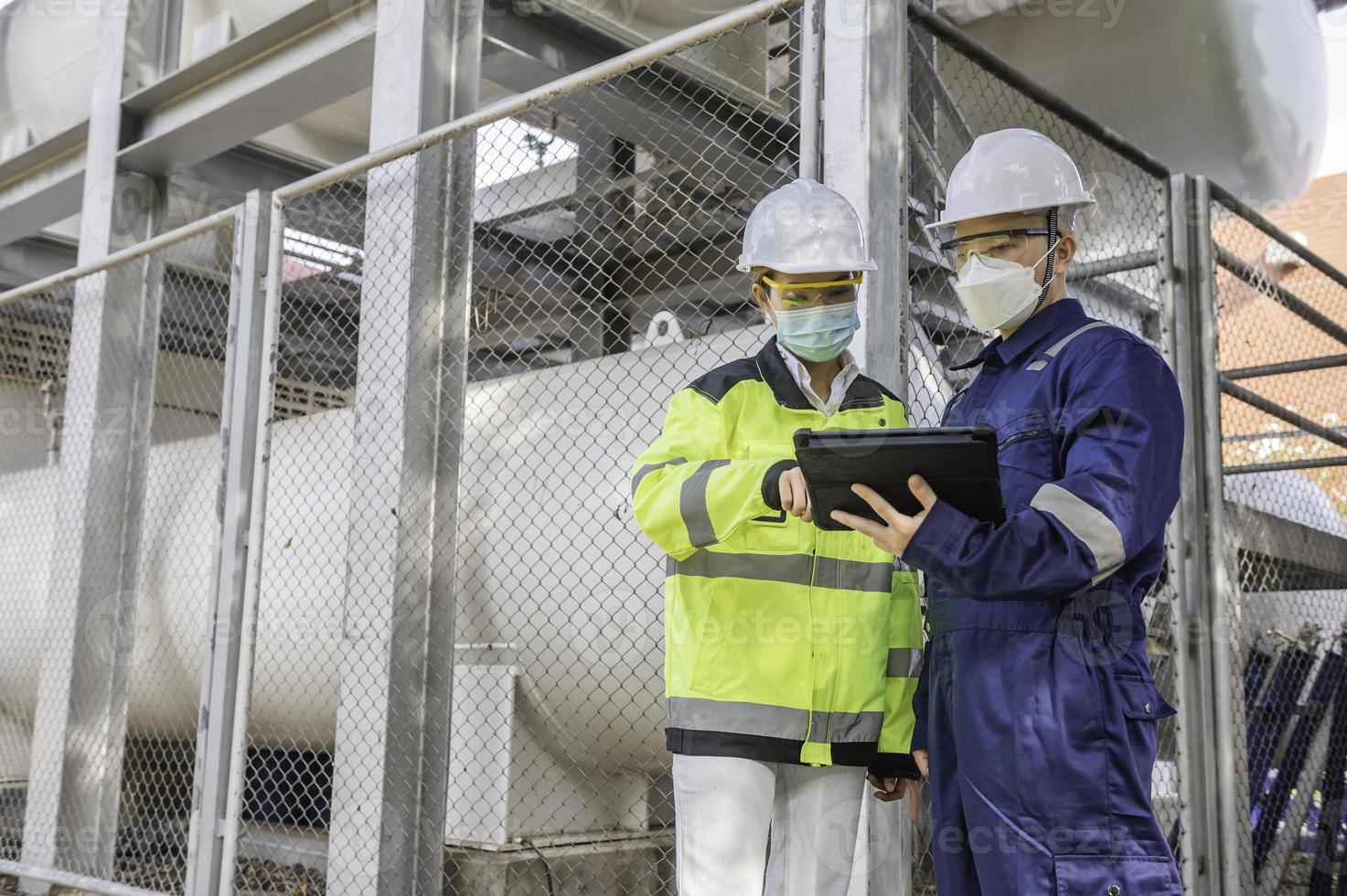 Engineers work place to keep liquid helium,preventive maintenance schedule checking,Thailand people,Technicians and engineers discuss work together. photo