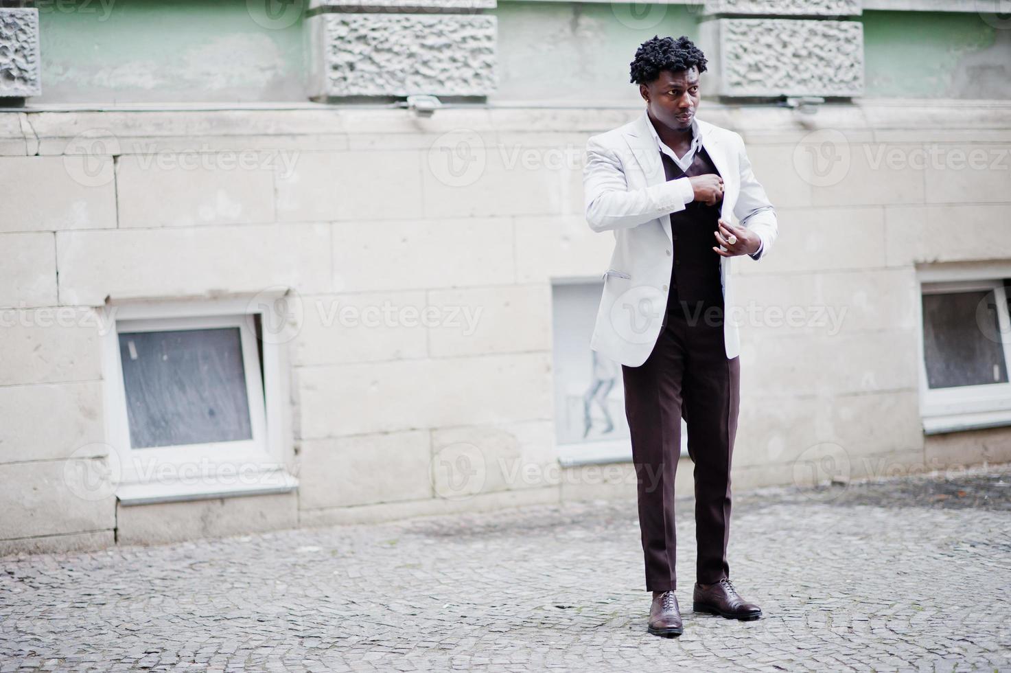 Thoughtful young handsome african american gentleman in formalwear. Black stylish model man in white jacket. photo