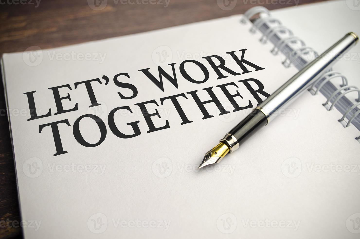 let's work together words on white notepad and pen photo