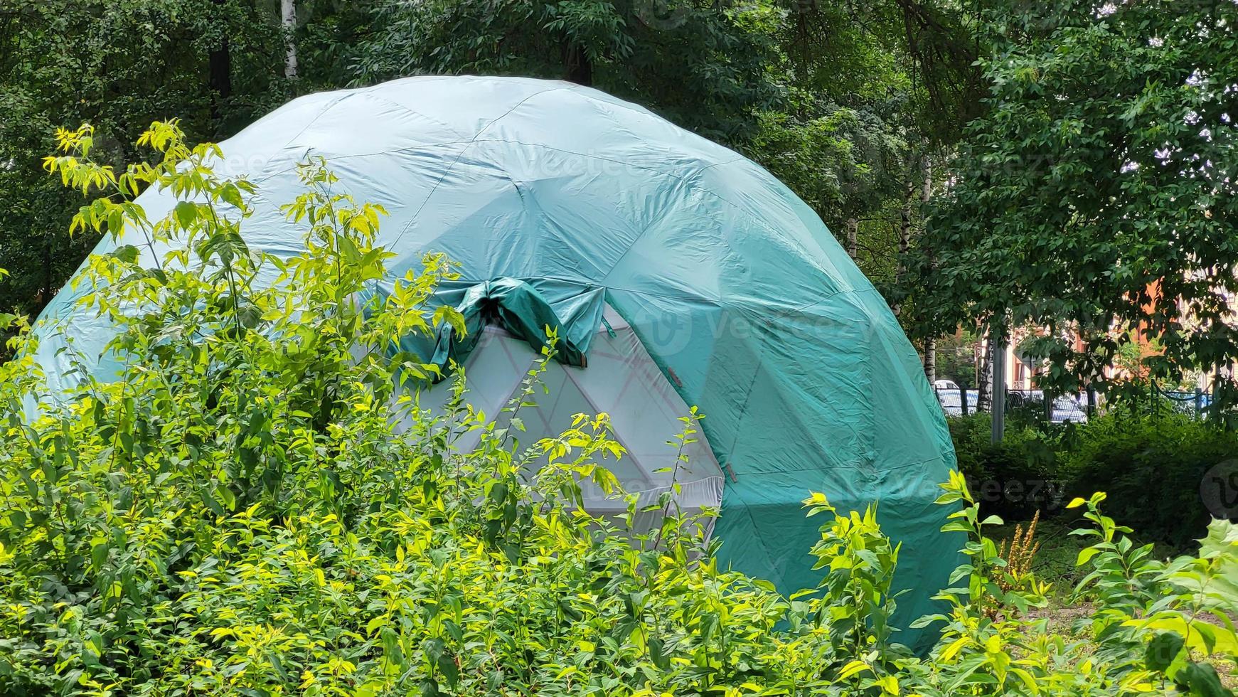 Large green dome geodesic tent for camping. Tourism concept photo