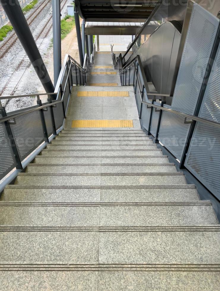 The braille block tile between the landing of the modern staircase. photo