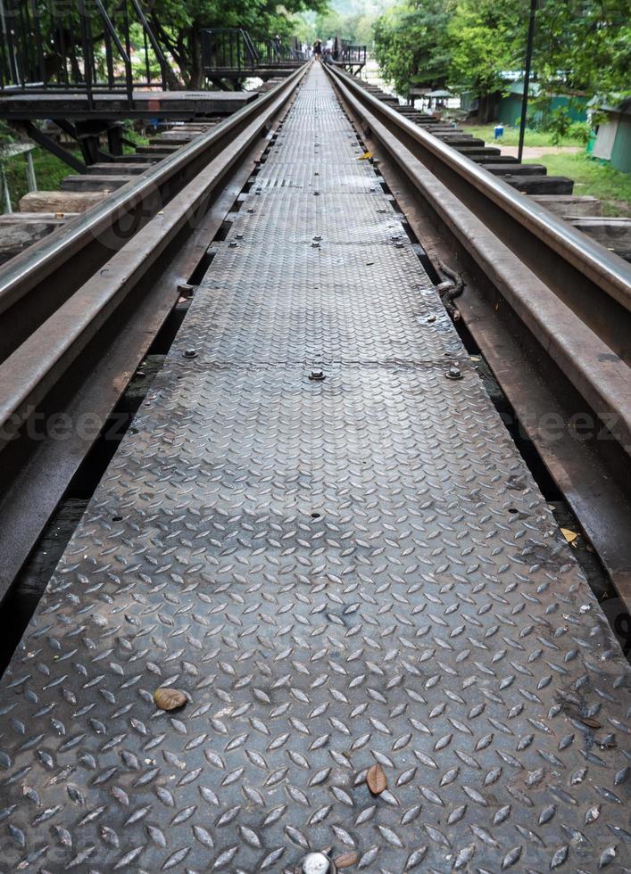 Closeup of the metal pathway on the old railway bridge. photo
