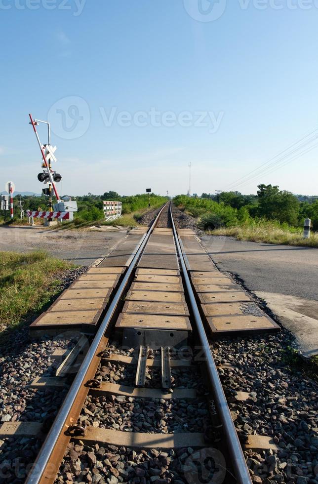 The automatic railroad crossing on the countryside road before the local train station. photo