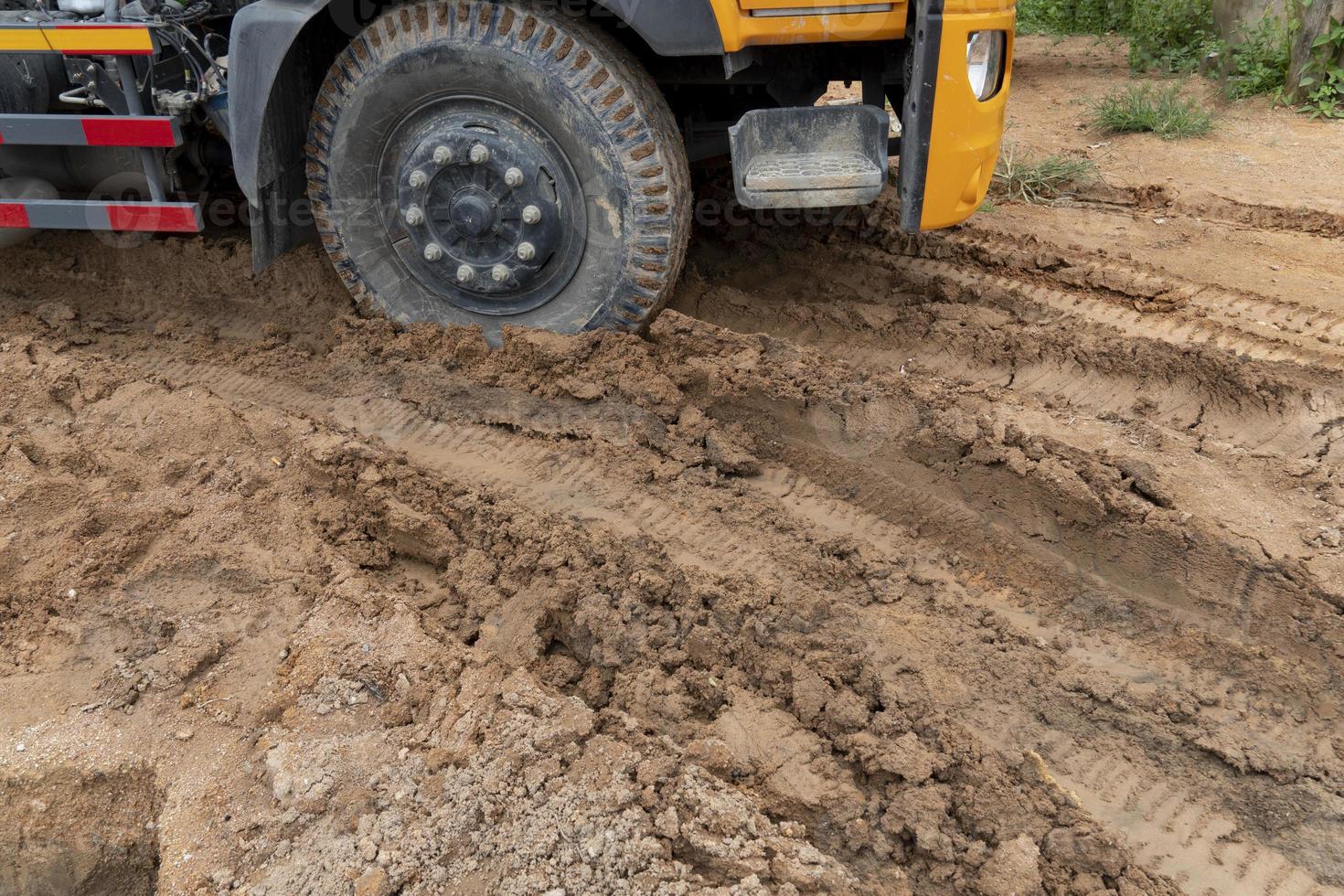 Big trucks drive on muddy roads. Liquid mud off road and there are