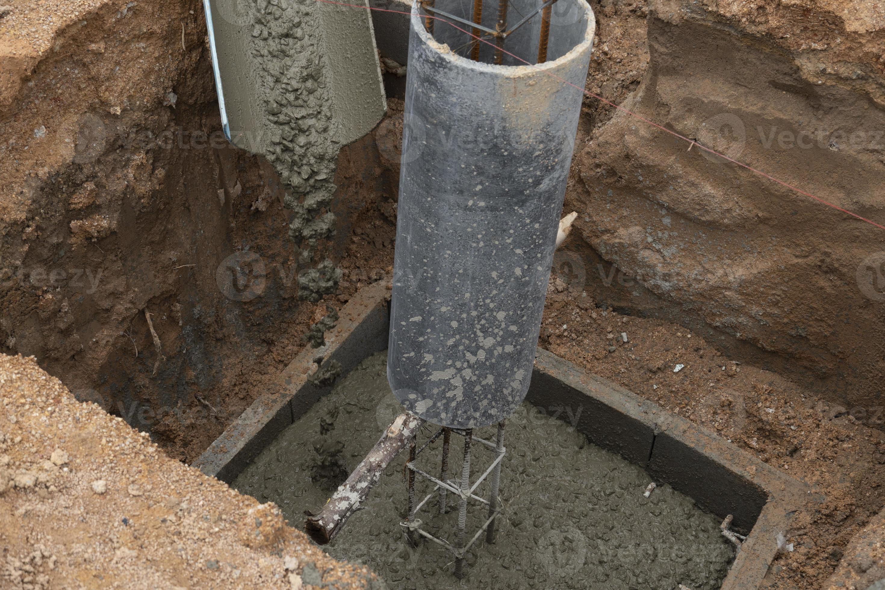 Stone cement mix that is poured onto the blocks. pillar base for building a  house. In a pit dug one meter deep. for the basics of building a new home.  10511188 Stock