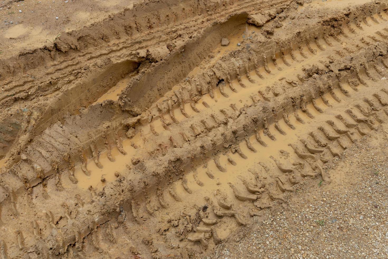 Tilt angle view of liquid mud off road and there are marks of tires. photo